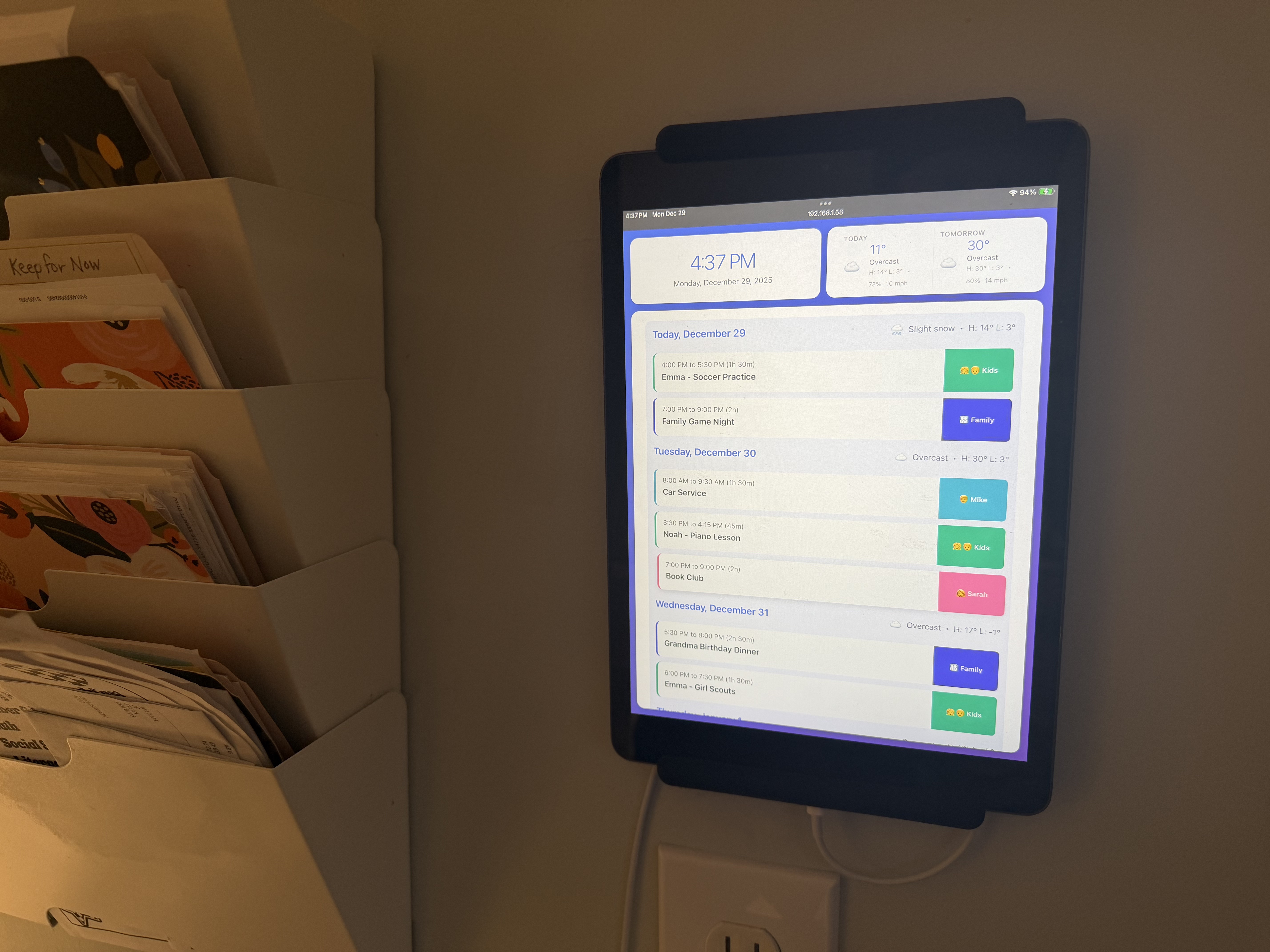 peeq dashboard on wall-mounted tablet by bookshelf